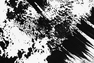 Patterns of black paint from a brush on a white background