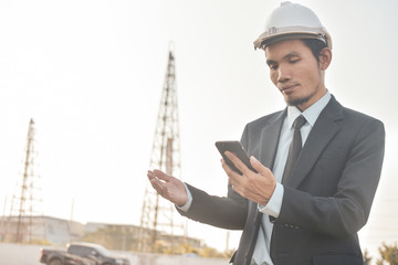 Businessman holding mobile smart phone communication building estate construction background