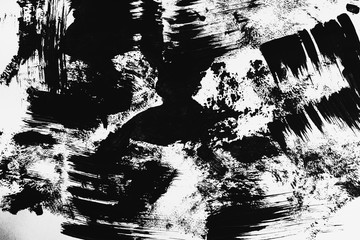 Patterns of black paint from a brush on a white background