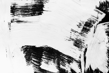 Patterns of white paint from a brush on a black background