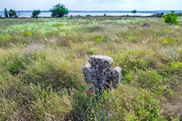 Stone tomb crosses on an ancient Christian necropolis of the 17th-19th centuries. The steppe hills on the right bank of the Dnipro river. Former settlements of Cossacks of Zaporizhzhya Sich in Ukraine