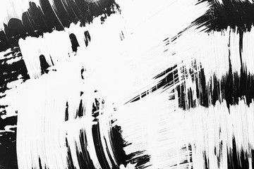 Patterns of white paint from a brush on a black background