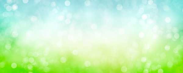 Fototapeta na wymiar Spring background with green blurred bokeh lights.
