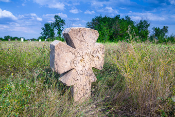 Stone tomb crosses on an ancient Christian necropolis of the 17th-19th centuries. The steppe hills on the right bank of the Dnipro river. Former settlements of Cossacks of Zaporizhzhya Sich in Ukraine