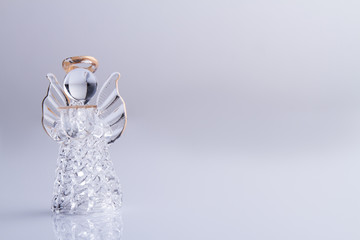 Glass angel with nimbus. Isolated on white, copyspace. - obrazy, fototapety, plakaty