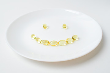 Smile formed with fish oil capsules.