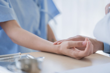 A doctor take care of sick patient woman at the hospital or medical clinic.