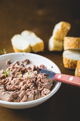 Pate with fresh bread on a wooden table