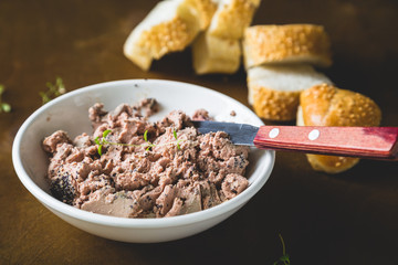 Pate with fresh bread on a wooden table