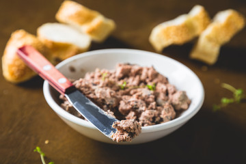 Pate with fresh bread on a wooden table