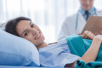The patient woman has smiling and happy in the hospital.
