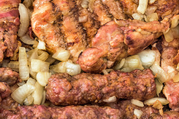 Barbecued Mixed Meat Kebabs and Chicken Thighs Served with Chopped Onion Detail