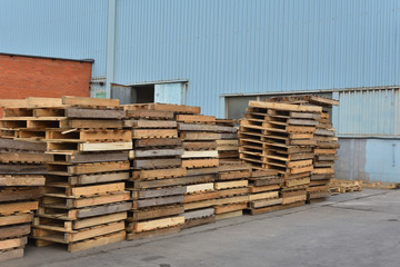 Wooden pallets in the open air at the factory. Many wooden pallets