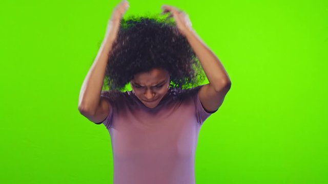 Angry annoyed black female gestures with annoyance, screams loudly, express irritation, wears casual lavender t-shirt, reproaches partner in betrayal, isolated over chromakey. Stop it, please, no.