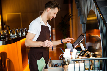 Caucasian male cafe worker doing his duties at work place