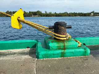 Ocean going ship tied to a bollard at the dock aith rat guard. - 318289385