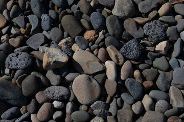 Sea stones background. Gray, white stones on the beach