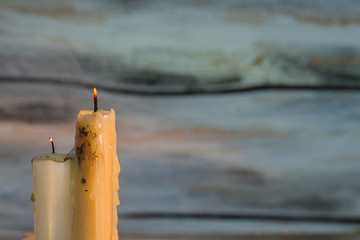 Two dirty extinguished candles on wooden background. Copyspace, free space for text.