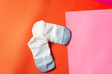 Sneaker or running socks on pink orange floor with copy text space