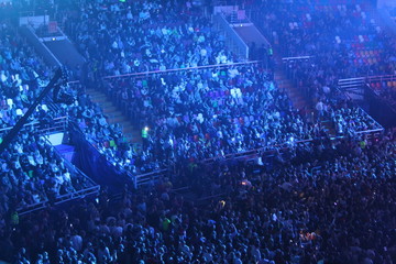 a crowd of people in a concert, sports hall at a concert