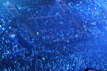 a crowd of people in a concert, sports hall at a concert