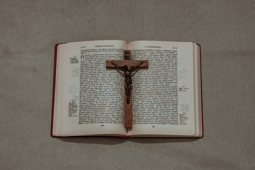 Old wooden Crucifix on the Holy Bible. Concept for exorcism or religious events