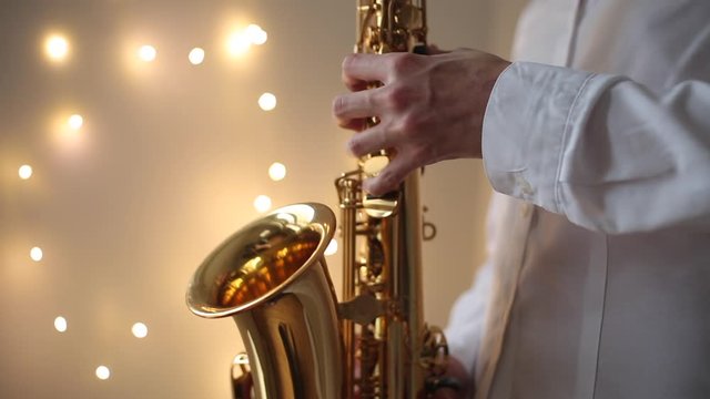 Hands of a musician playing the saxophone.