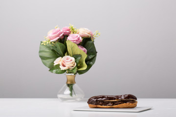 details of tasty conceptual eclair, on a plate, with gray background