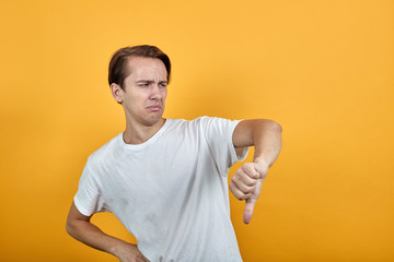 Man shows negative gesture male. Thumb is down