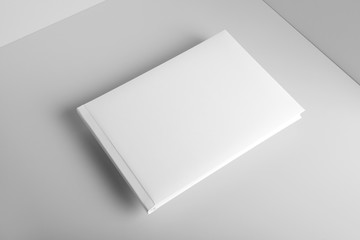 Blank landscape hardcover brochure magazine isolated on cardboard background, with clipping path, changeable background