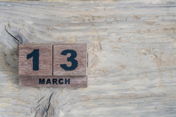 cube calendar for march on wooden background with copy space