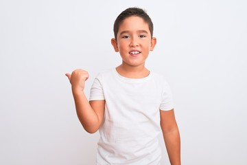 Beautiful kid boy wearing casual t-shirt standing over isolated white background smiling with happy...