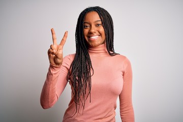 Young african american woman standing casual and cool over white isolated background showing and...