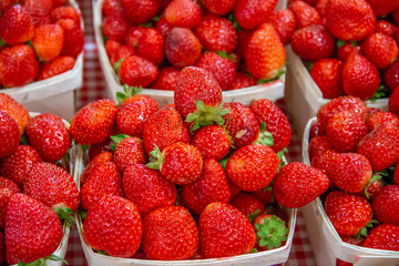 Fresh pile of strawberries for sale at a farmers market 