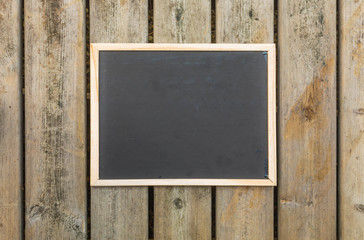 Vintage slate chalk board in wooden frame  on wooden background