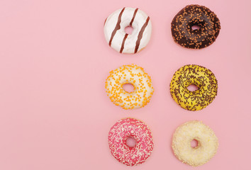 Fototapeta na wymiar Delicious donuts on violet color background.