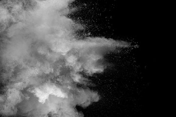 Explosion of white dust on black background.