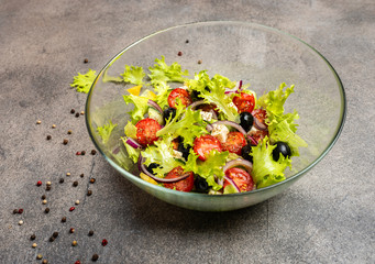 Greek salad with feta cheese, organic black olives, juicy tomatoes, red pepper, red onion, cucumber and lettuce.