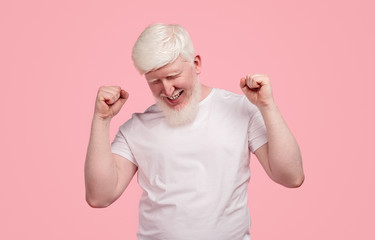 Happy albino man celebrating success