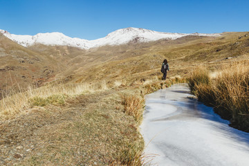 Unknown woman hiking on high mountains. Sierra Nevada, Granada, Spain.