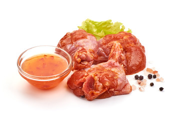 Raw chicken legs in a barbecue marinade, isolated on white background