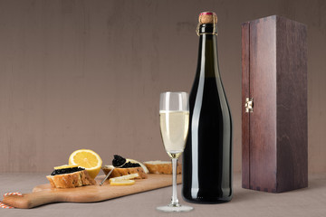Champagne bottle mockup, on wooden background, with glass, caviar and blank label to place your design
