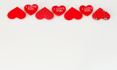 Hearts on a white background. Valentine's Day top view Copy the area on the flat greeting card.