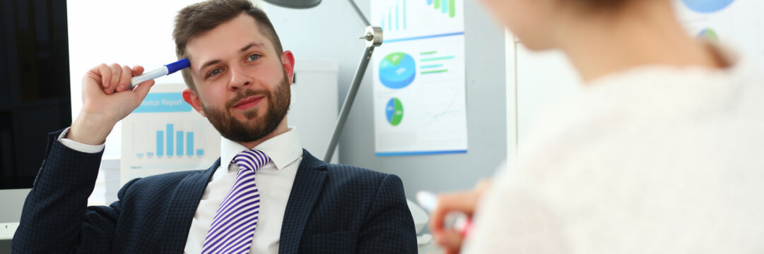 Portrait Of Handsome Smiling Man. Board Member Speaking And Ask Questions To Manager About Financial Statements. Company And Business Meeting Concept. Blurred Background