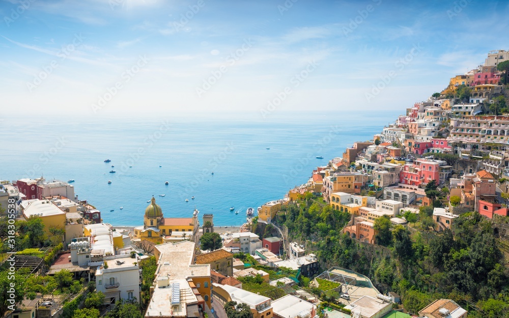 Wall mural beautiful positano on hills leading down to coast and azure sea, italy