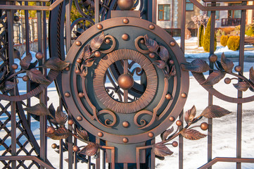 Beautiful forged elements on the fence. Red rusty metal