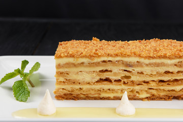 Esterhazy traditional cake on a white plate with mint