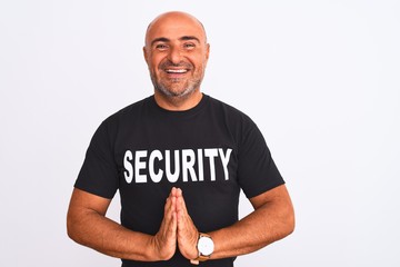 Middle age safeguard man wearing security uniform standing over isolated white background praying with hands together asking for forgiveness smiling confident.