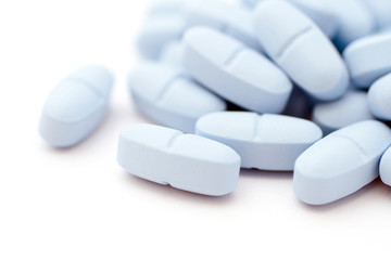 Blue pills on white background