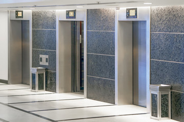 Three elevator doors in office building. Wide angle view of modern elevators with doors. Elevators...